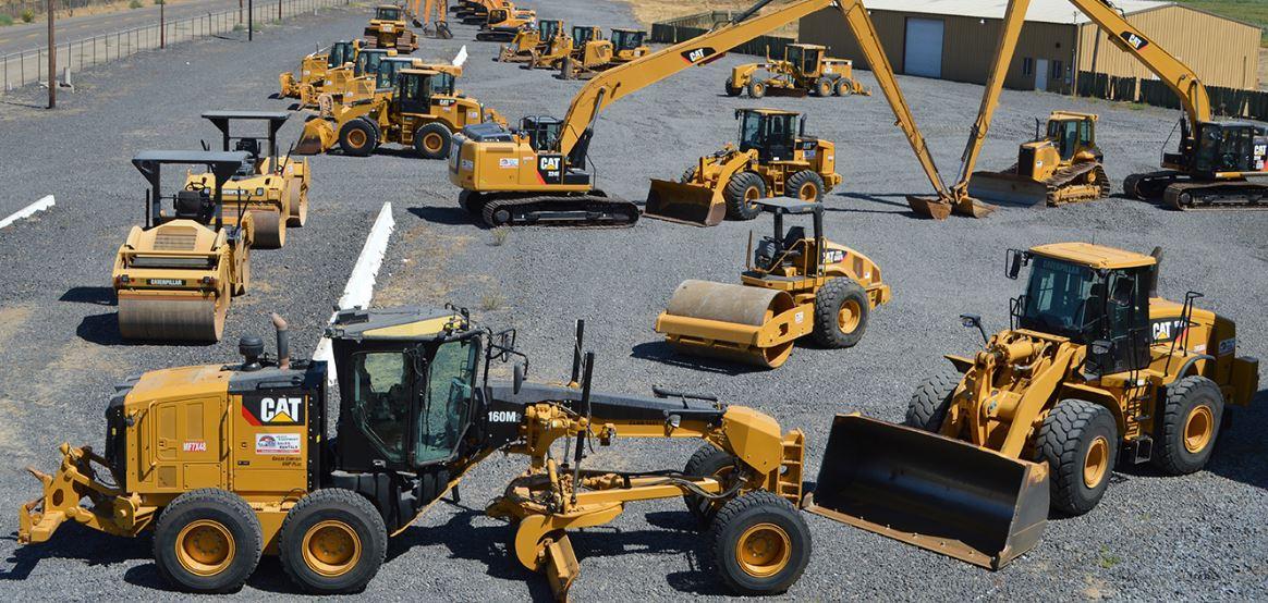Excavators and heavy construction equipment in a yard